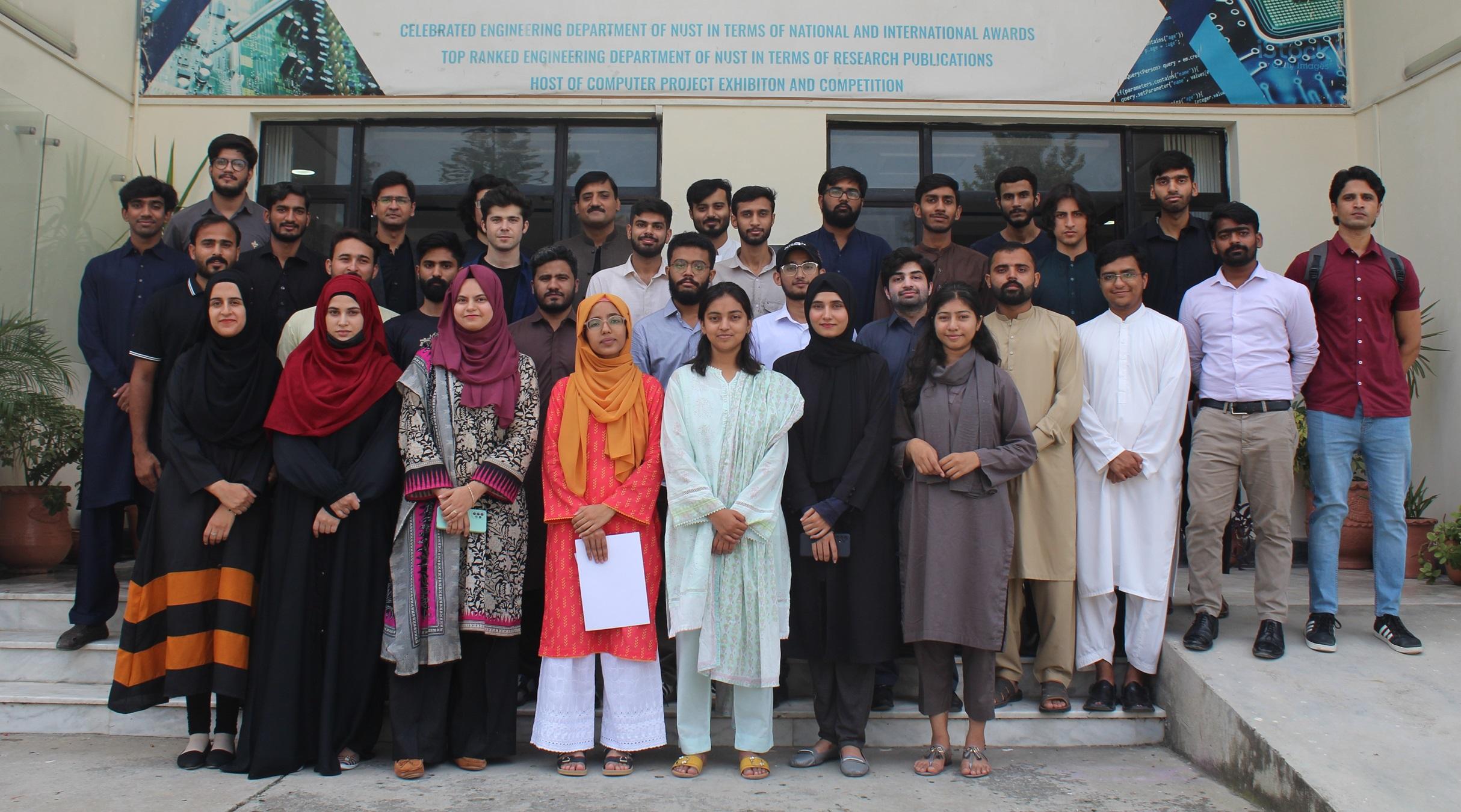 Group photo of RiseTech team members standing in front of a building
